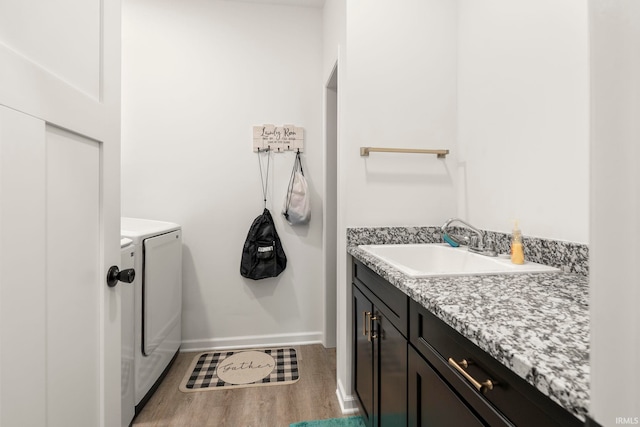 bathroom with vanity, separate washer and dryer, and hardwood / wood-style floors