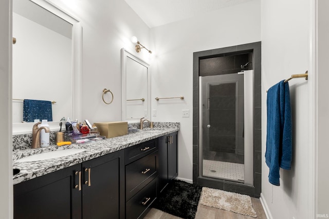 bathroom featuring vanity and an enclosed shower