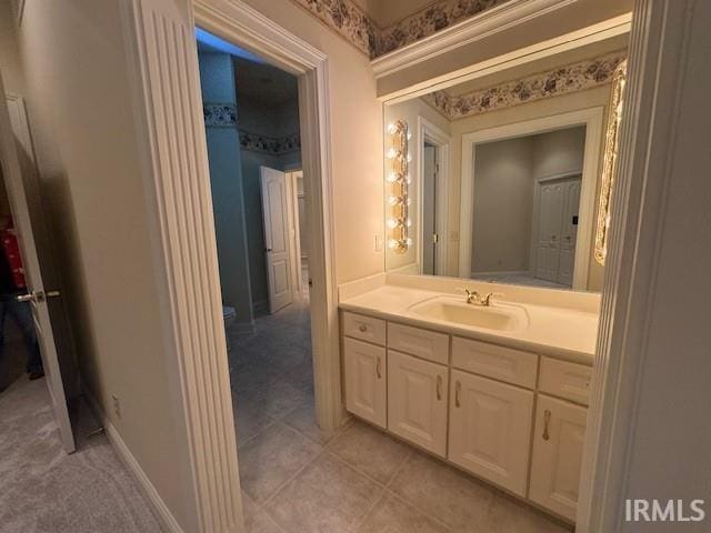 bathroom with tile patterned flooring and vanity