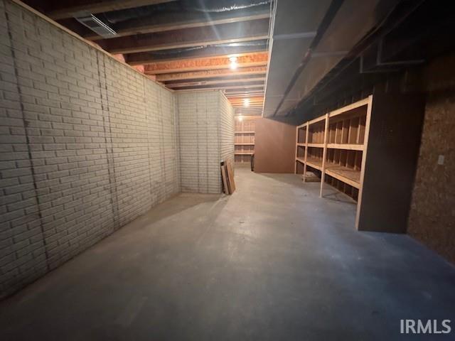 basement with brick wall