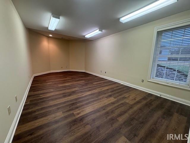 empty room with dark wood-type flooring