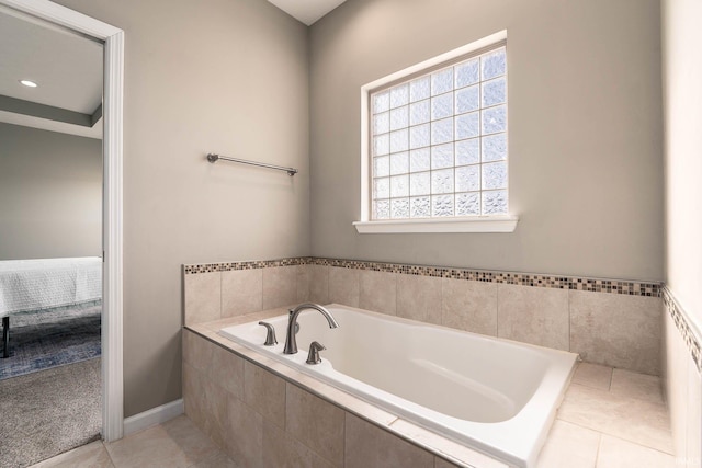 bathroom featuring tile patterned flooring and tiled tub