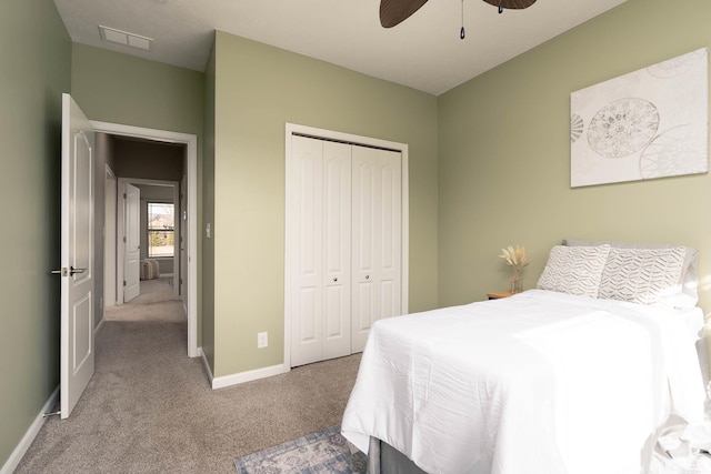 carpeted bedroom with ceiling fan and a closet