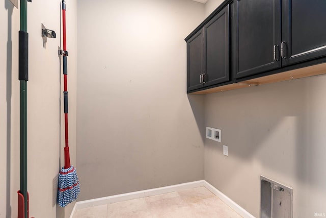 laundry room featuring cabinets, hookup for a washing machine, and light tile patterned floors