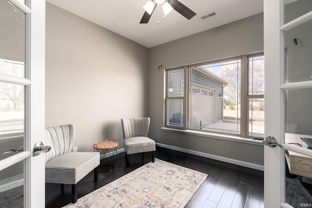 sitting room featuring dark hardwood / wood-style floors and ceiling fan