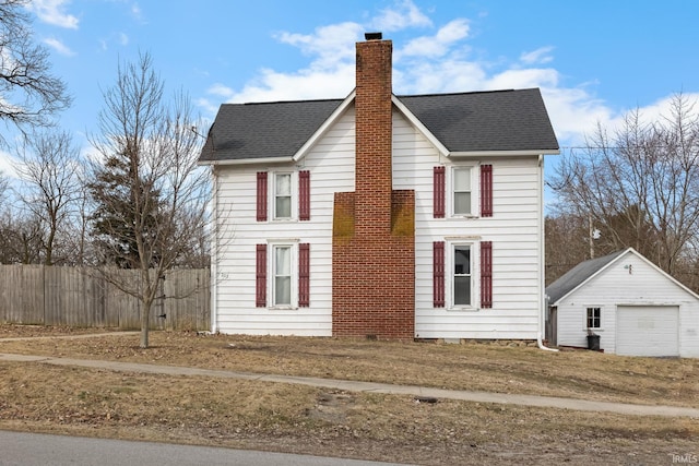 view of front of property featuring an outbuilding and a garage