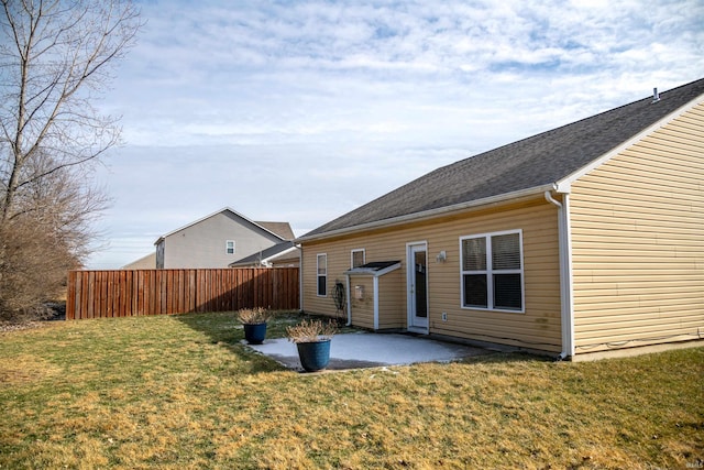 rear view of house with a yard and a patio area