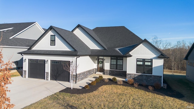 view of front of home featuring a garage and a front lawn