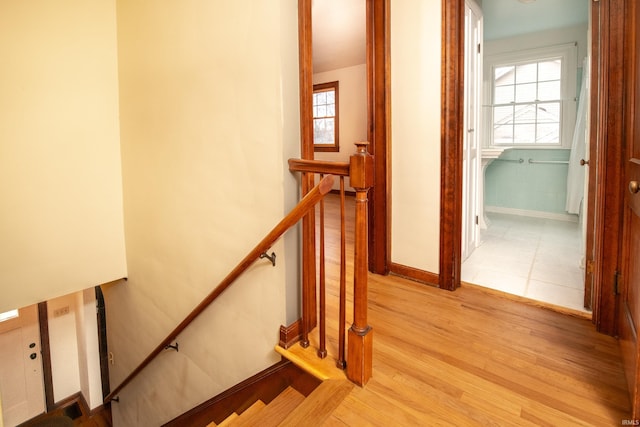 stairs featuring wood-type flooring