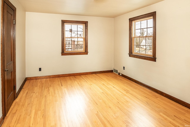 empty room with light hardwood / wood-style floors