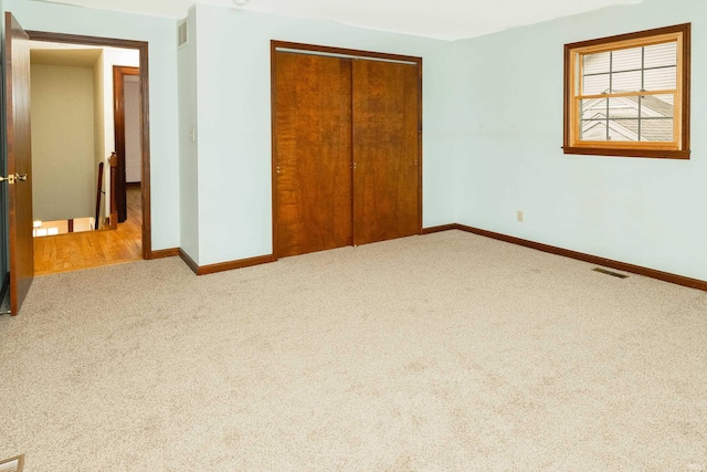 unfurnished bedroom with carpet floors and a closet