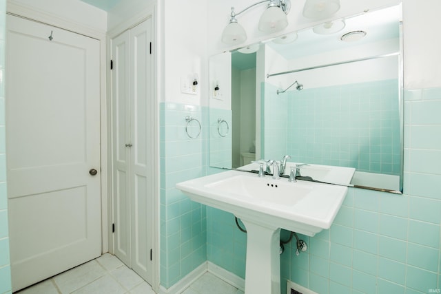 bathroom with tile walls and tile patterned floors