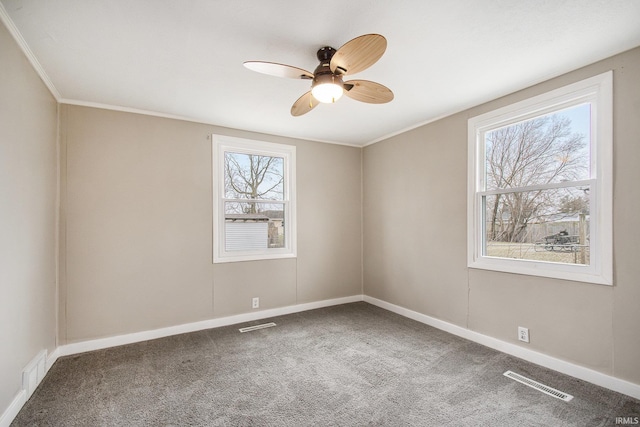 carpeted spare room featuring crown molding and ceiling fan