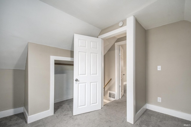 bonus room featuring lofted ceiling and carpet flooring