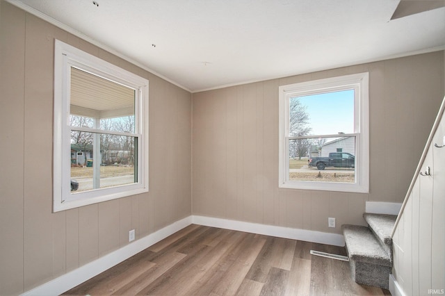 unfurnished room featuring hardwood / wood-style floors and a wealth of natural light