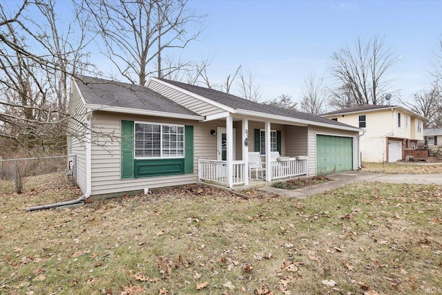 view of front of property with a garage, covered porch, and a front lawn