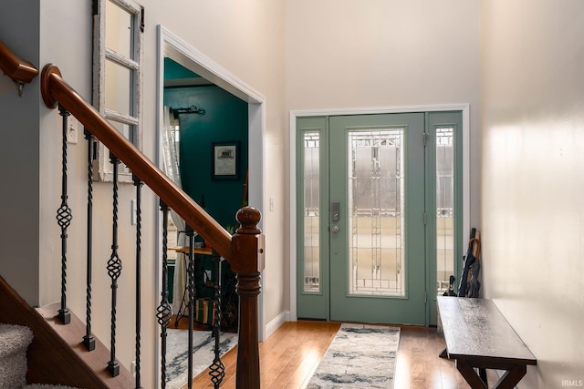 foyer with light hardwood / wood-style flooring and a high ceiling