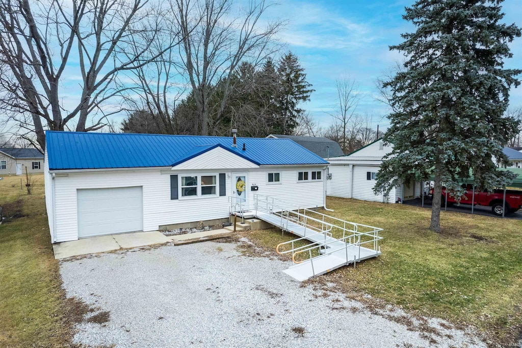 single story home with a garage and a front yard