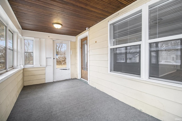 unfurnished sunroom with wooden ceiling