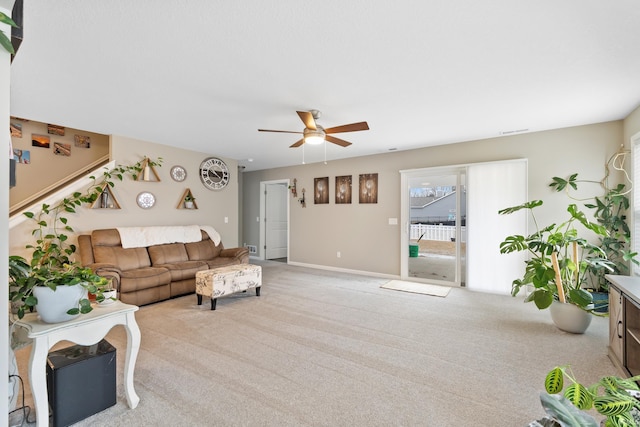 carpeted living room with ceiling fan