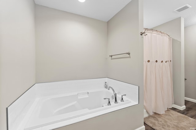 bathroom with shower with separate bathtub and hardwood / wood-style floors