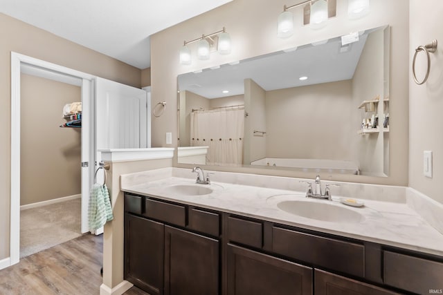 bathroom featuring hardwood / wood-style flooring and vanity