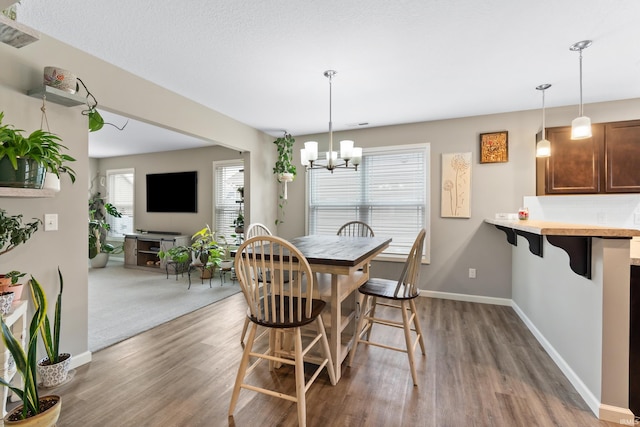 dining room featuring dark wood-type flooring and a chandelier