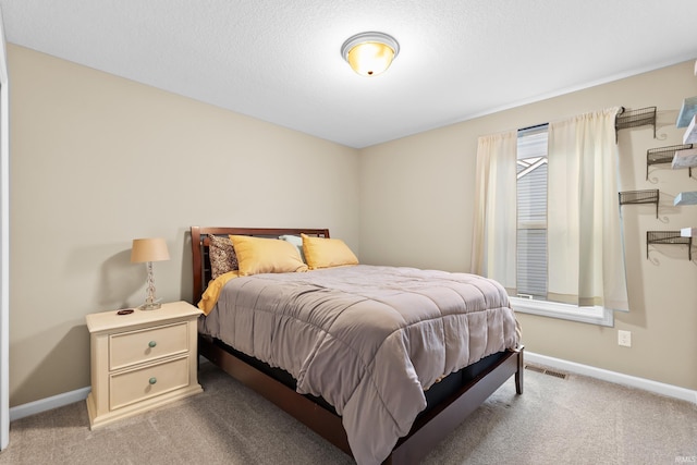 carpeted bedroom with a textured ceiling