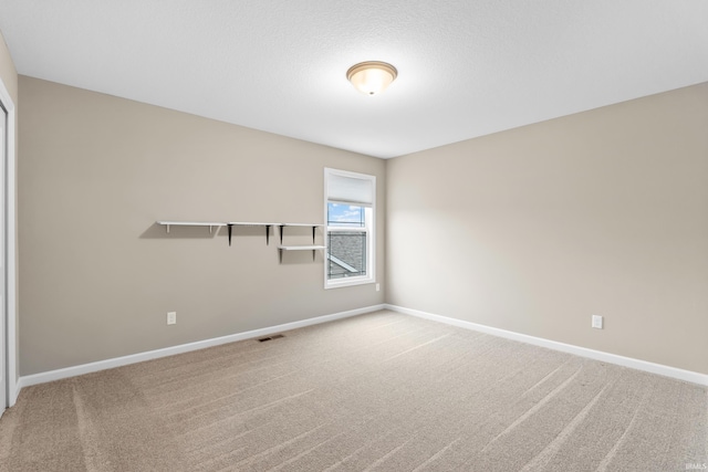 unfurnished room featuring carpet