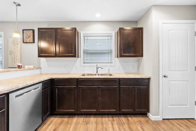 kitchen with sink, light hardwood / wood-style flooring, dishwasher, pendant lighting, and decorative backsplash