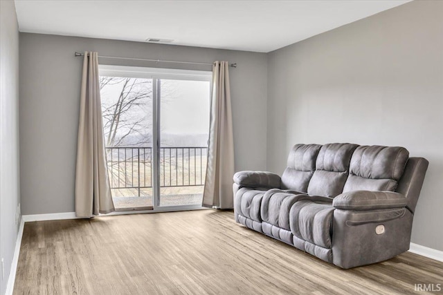 living area with hardwood / wood-style floors