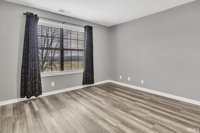 spare room with wood-type flooring