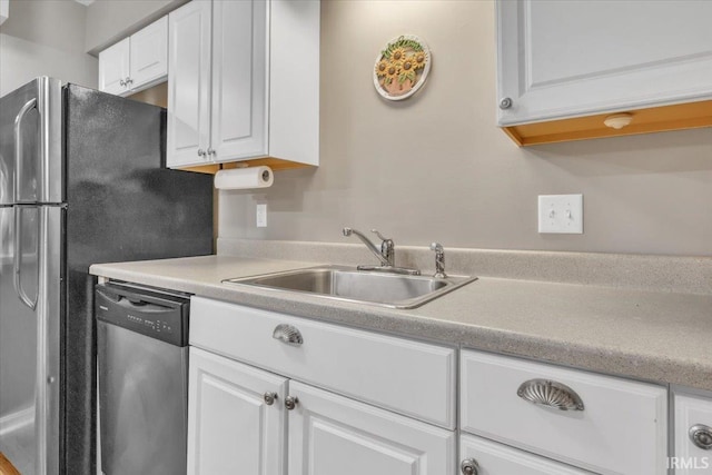 kitchen featuring white cabinetry, appliances with stainless steel finishes, and sink