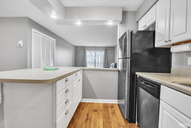 kitchen featuring white cabinets, light hardwood / wood-style floors, kitchen peninsula, and dishwasher