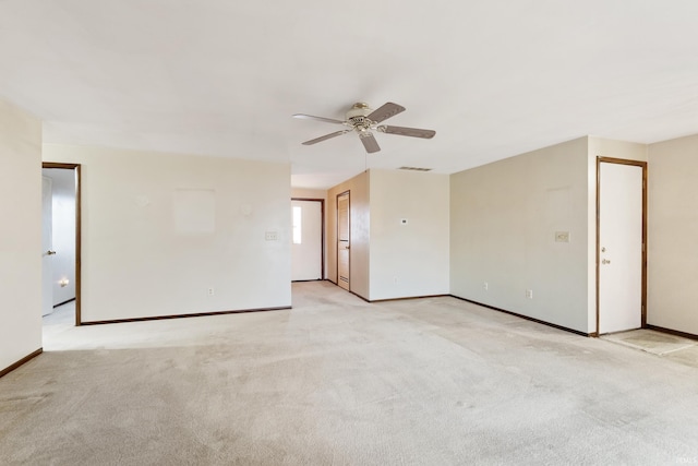 carpeted spare room with ceiling fan