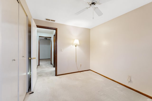 interior space featuring light colored carpet and ceiling fan