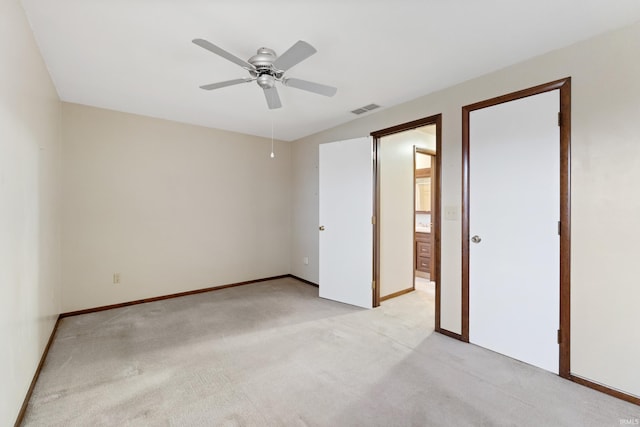 unfurnished bedroom featuring light colored carpet and ceiling fan