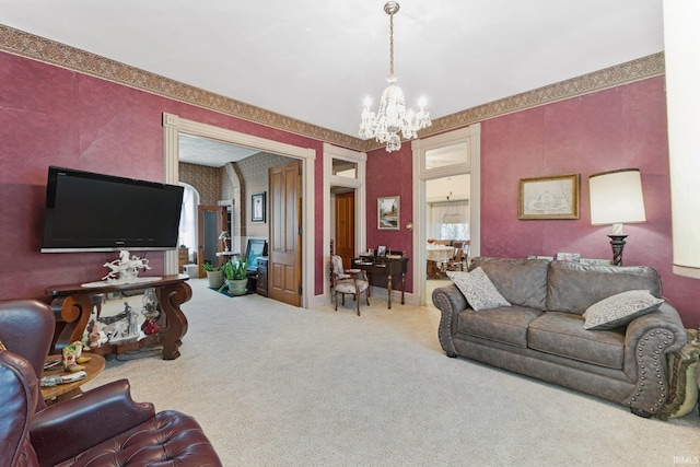 carpeted living room featuring a chandelier