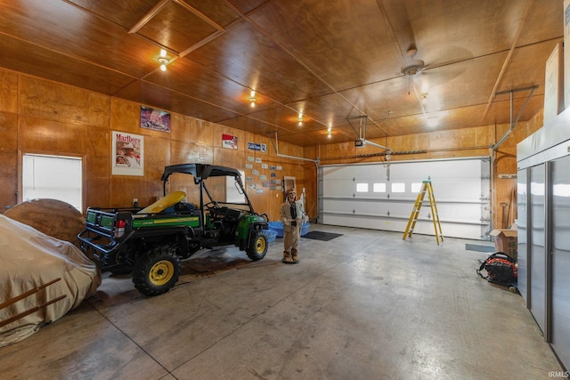 garage featuring wood walls