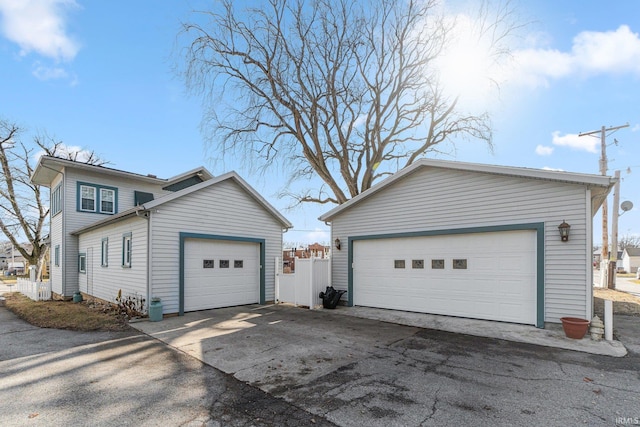 view of property exterior featuring a garage and an outbuilding