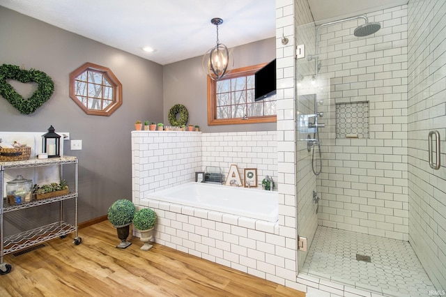 bathroom featuring hardwood / wood-style flooring and separate shower and tub