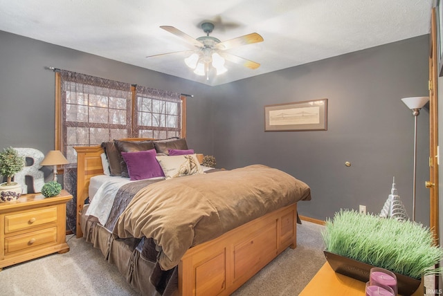 bedroom with light colored carpet and ceiling fan