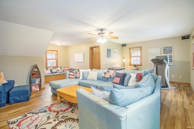 living room with ceiling fan and light wood-type flooring