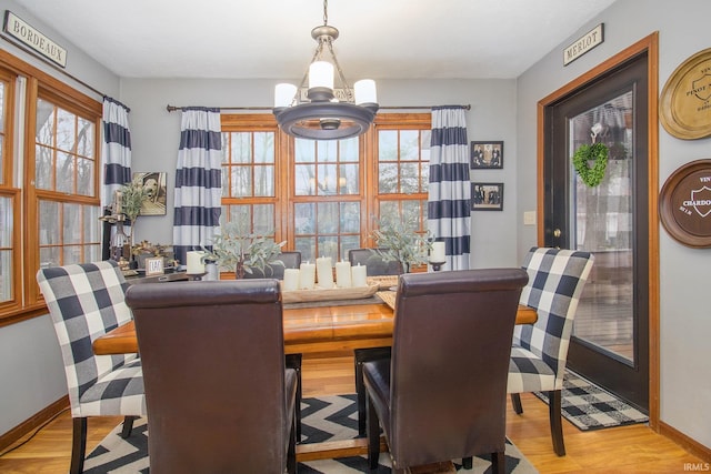 dining room with a notable chandelier and light wood-type flooring