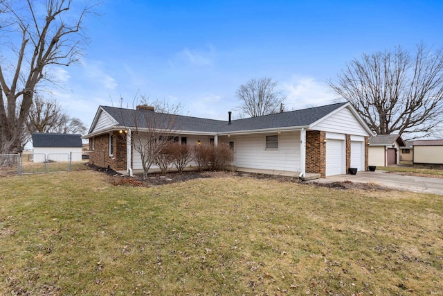 view of front of home with a garage and a front lawn