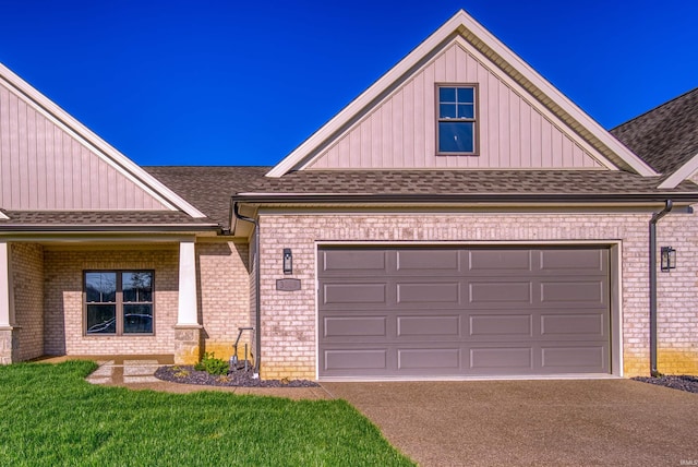 craftsman inspired home with a garage and a front lawn