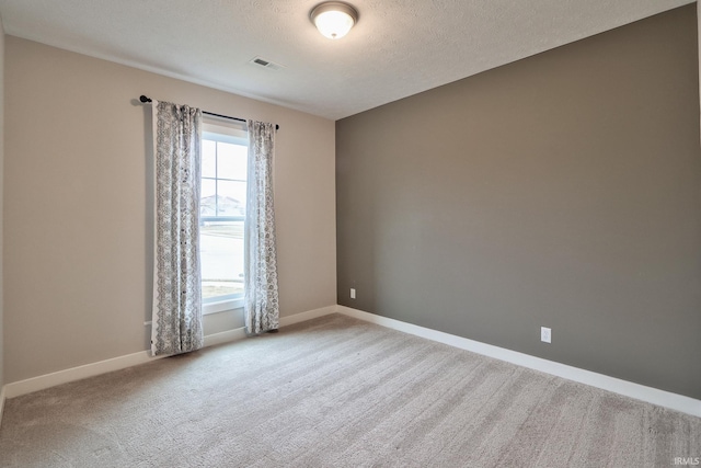 unfurnished room with a textured ceiling and carpet