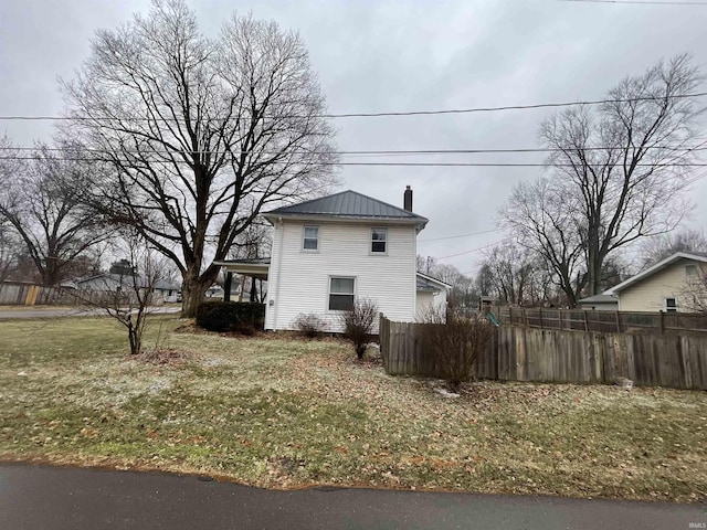 view of side of property with a yard