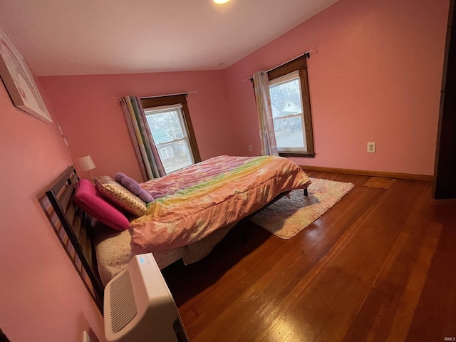 bedroom featuring hardwood / wood-style floors and multiple windows