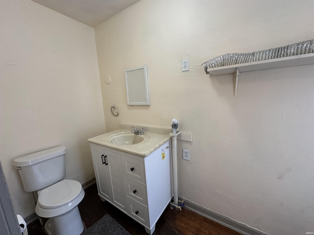 bathroom featuring vanity, hardwood / wood-style flooring, and toilet